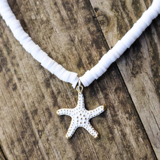 Necklace with a starfish pendant on a wooden surface