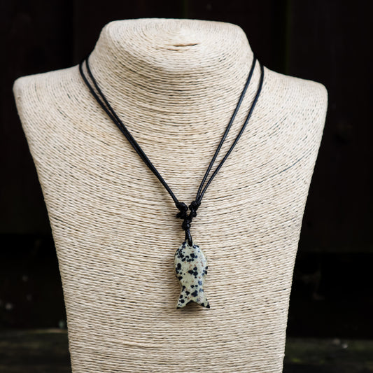 Necklace with a dalmatian jasper fish pendant on a mannequin bust.