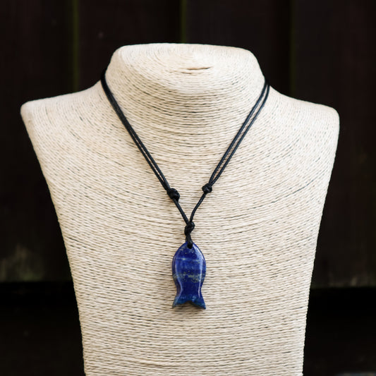 Blue fish-shaped pendant on a black cord displayed on a mannequin bust.
