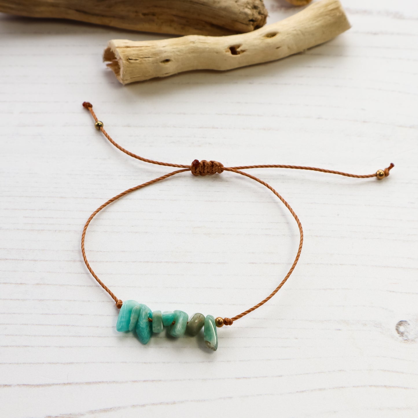Bracelet with turquoise beads on a white wooden surface