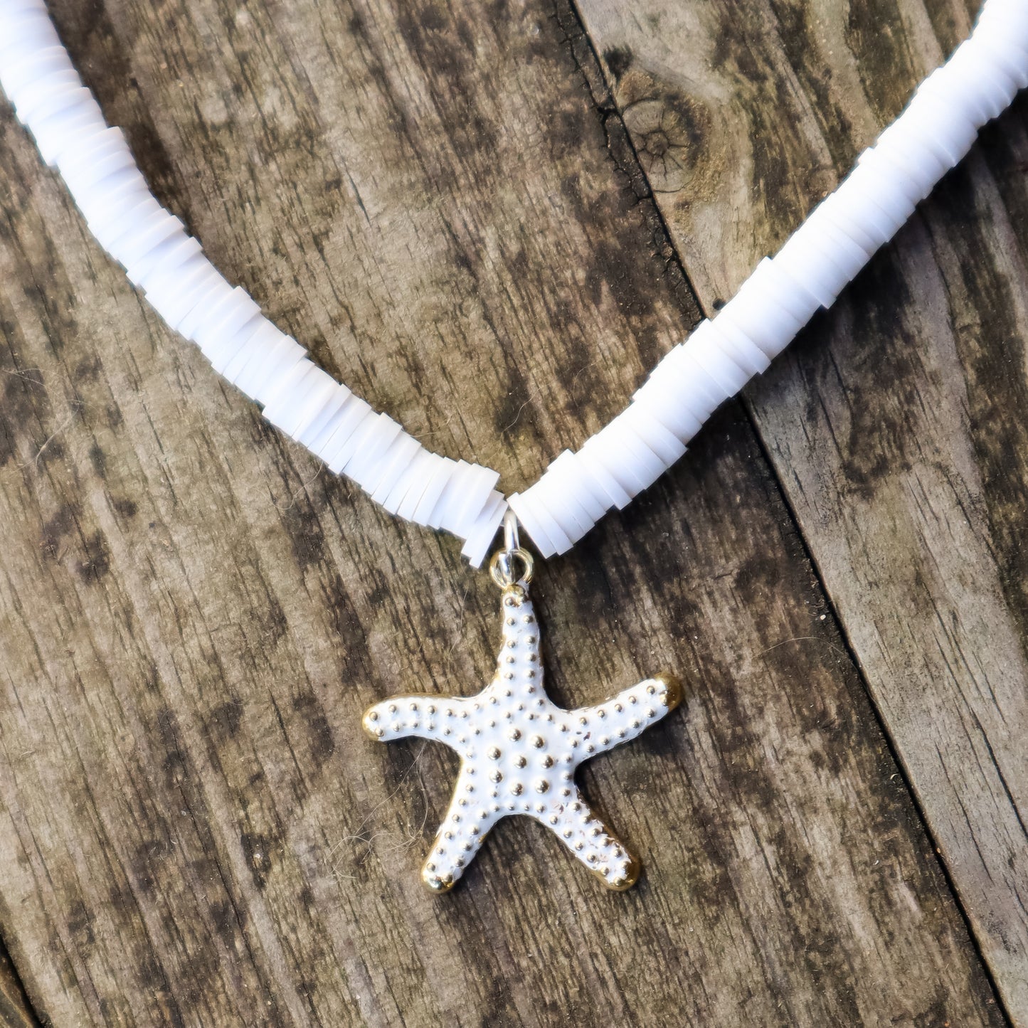 Necklace with a starfish pendant on a wooden surface
