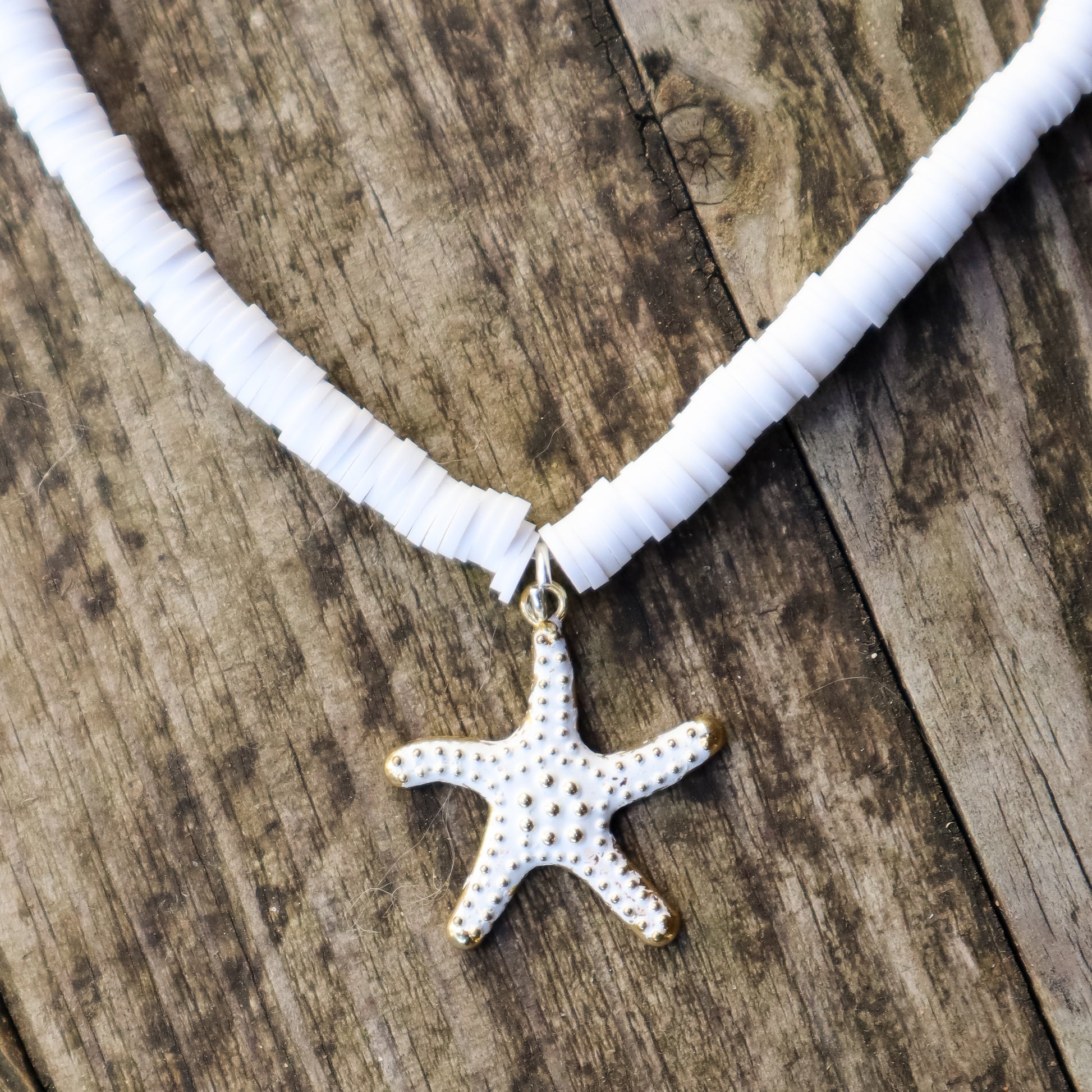 Necklace with a starfish pendant on a wooden surface