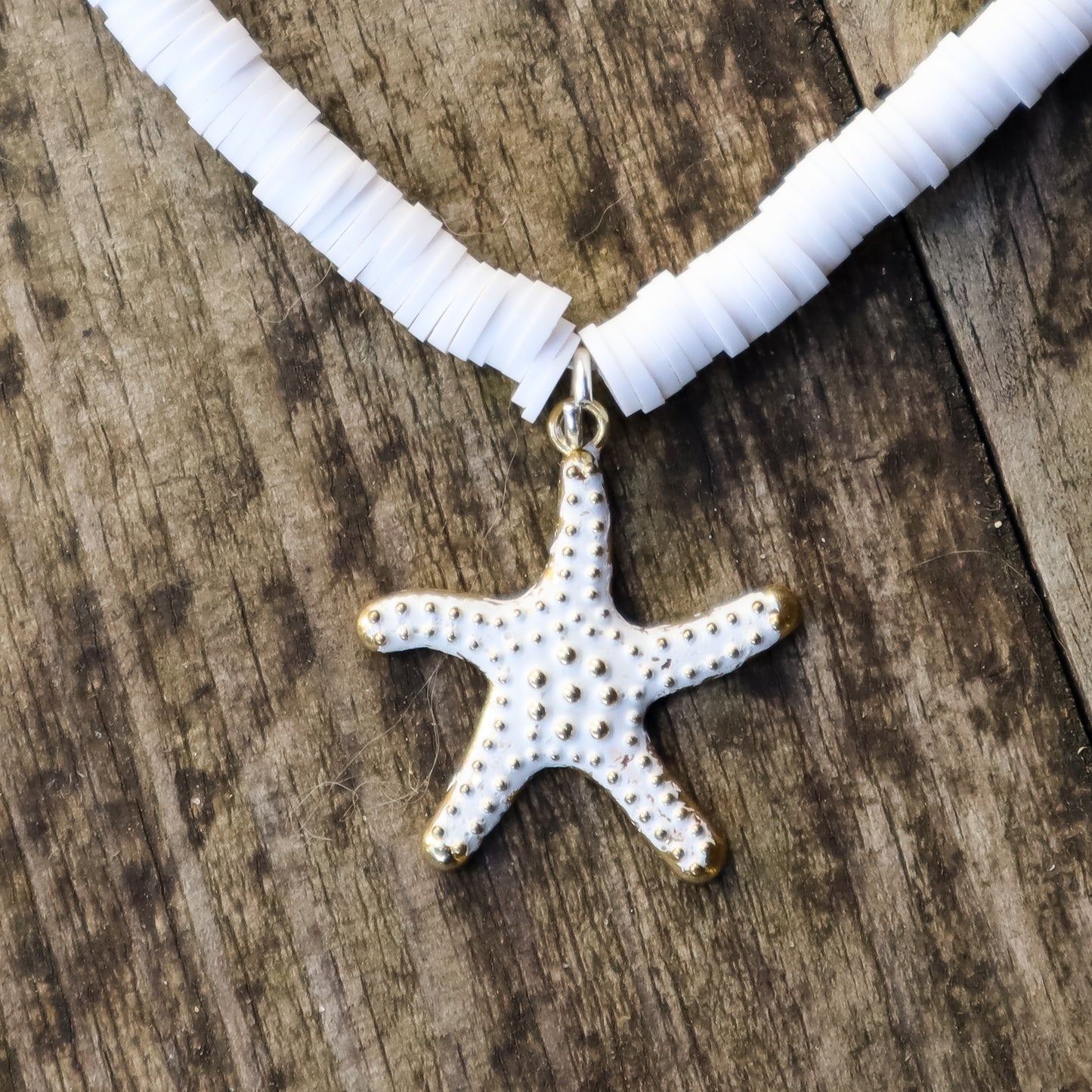 Necklace with a starfish pendant on a wooden surface