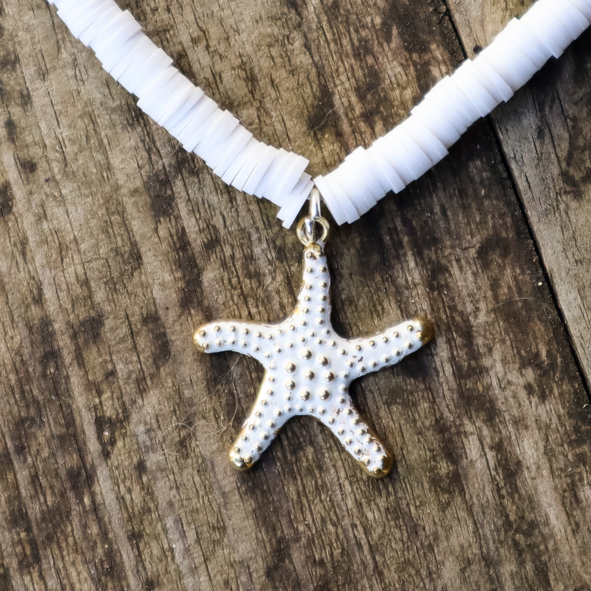 Necklace with a starfish pendant on a wooden surface