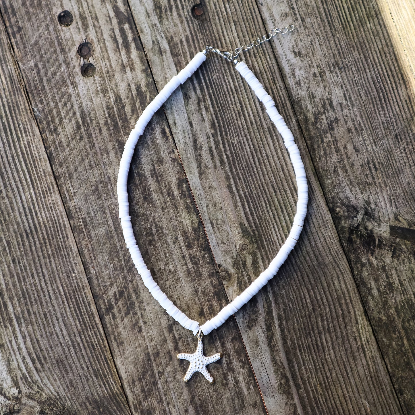Necklace with a starfish pendant on a wooden surface