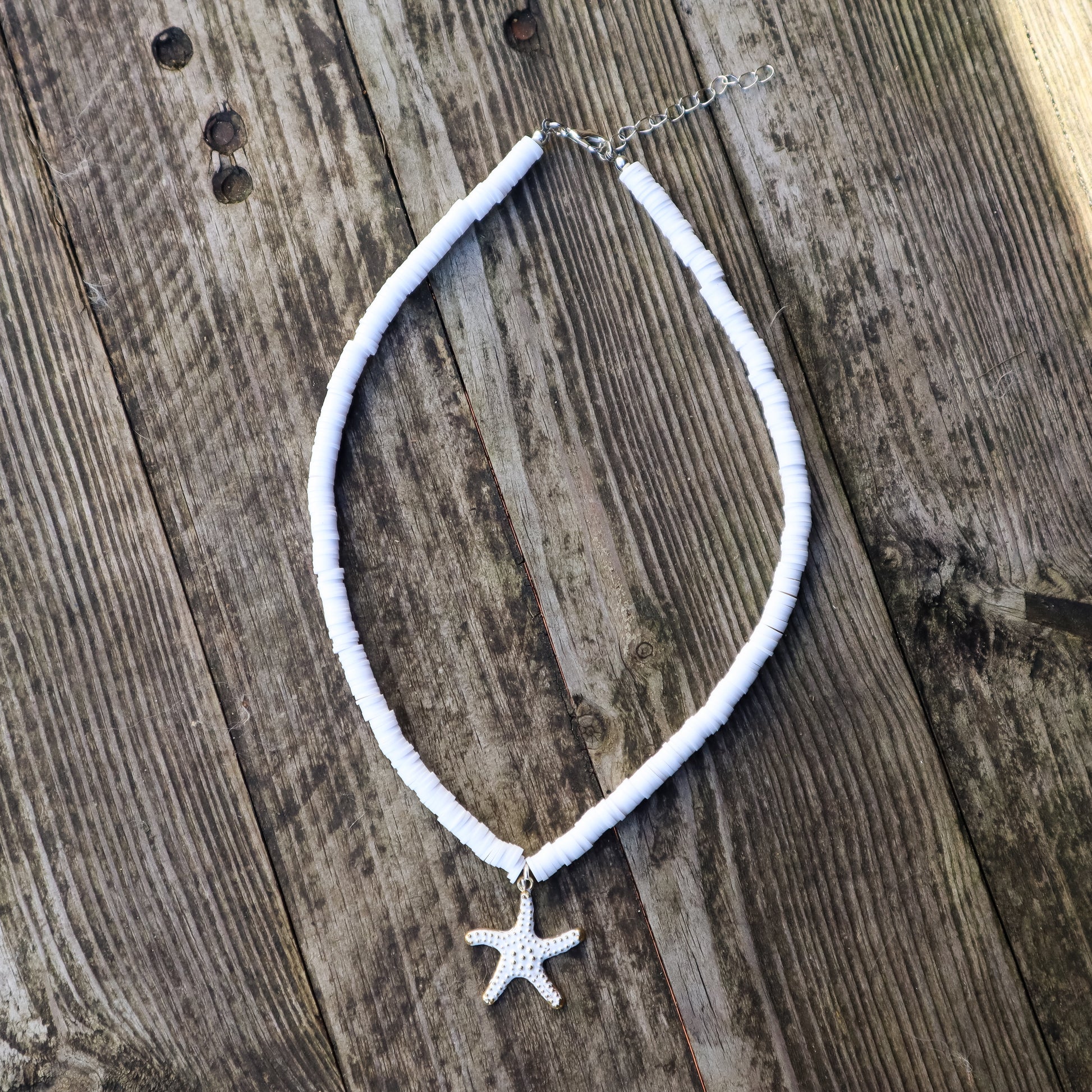 Necklace with a starfish pendant on a wooden surface